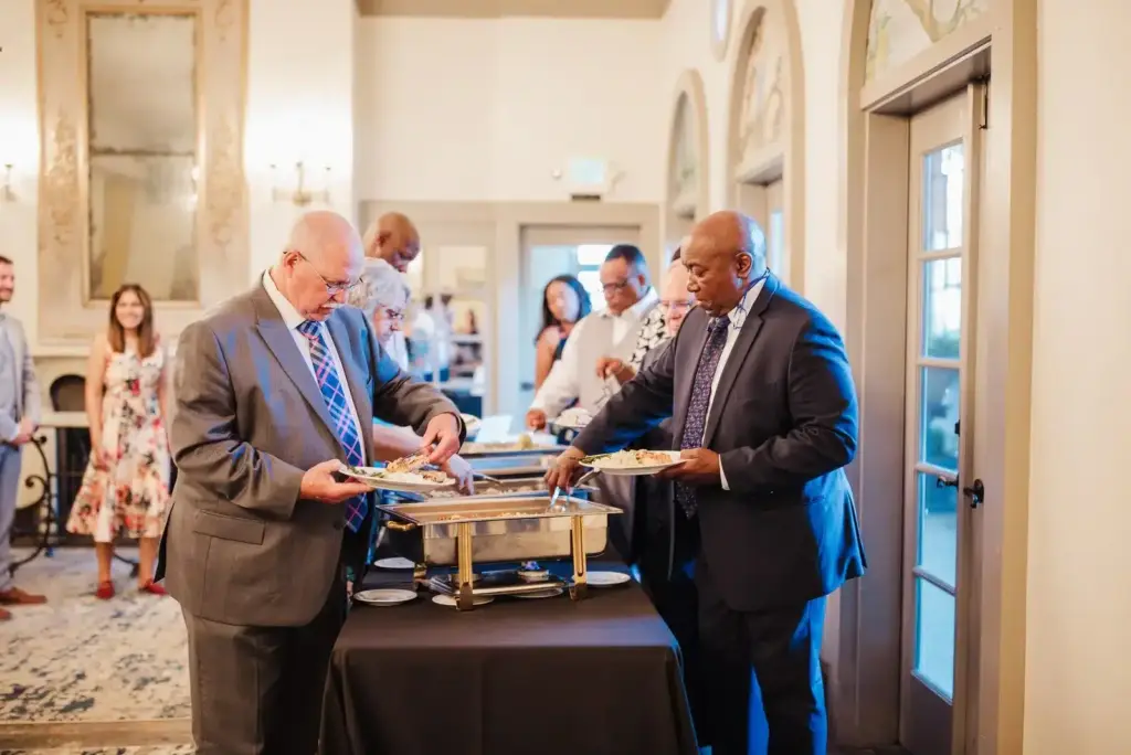 Guests serving themselves from a Herban Feast buffet at a company event at The Ruins