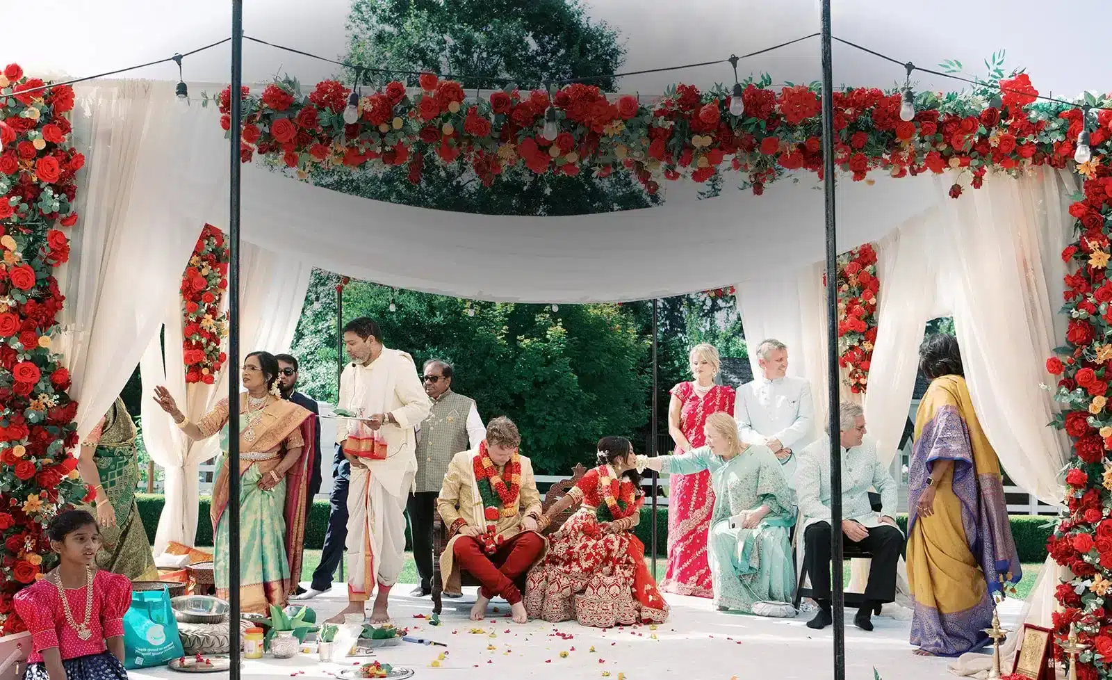 A Hindu wedding ceremony beneath a flower-covered mandap on the lawn at Fox Hollow Farm, Issaquah