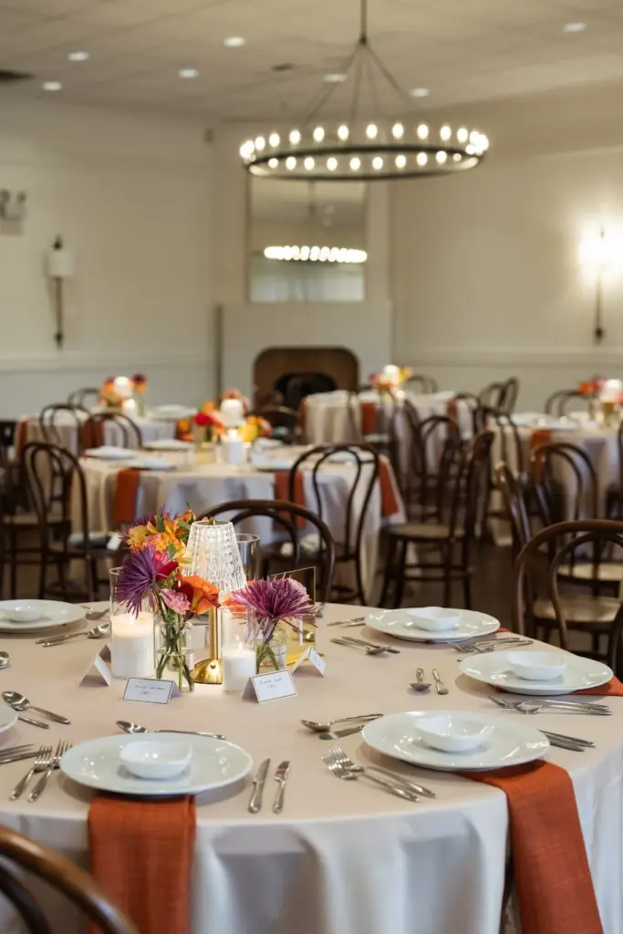 The ballroom at Columbia Collective set with round tables and centerpieces for a seated dinner