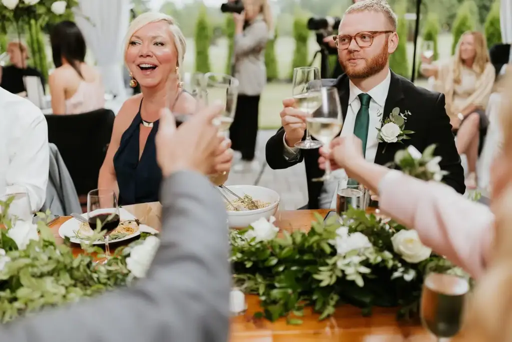 Wedding guests raising a toast at dinner at Gray Bridge, a wedding venue near Seattle