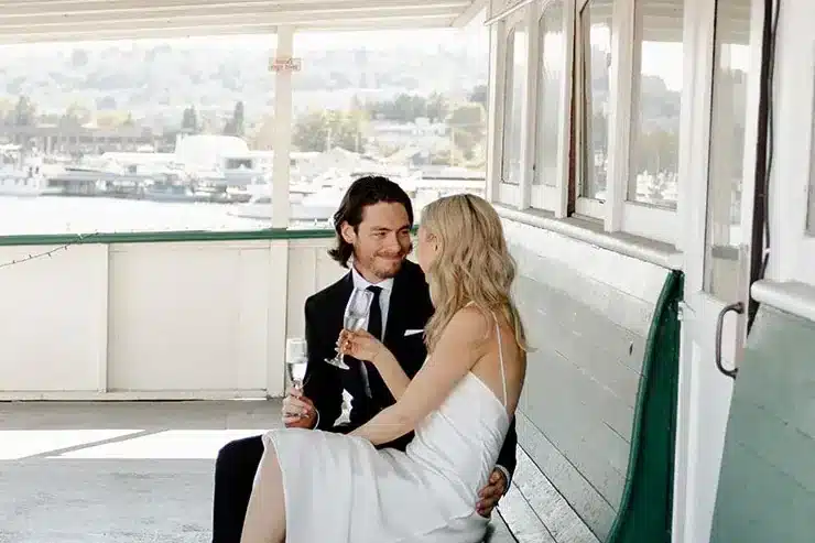Newlyweds sharing a quiet moment on the deck of the MV Skansonia on Lake Union, an intimate Seattle wedding venue