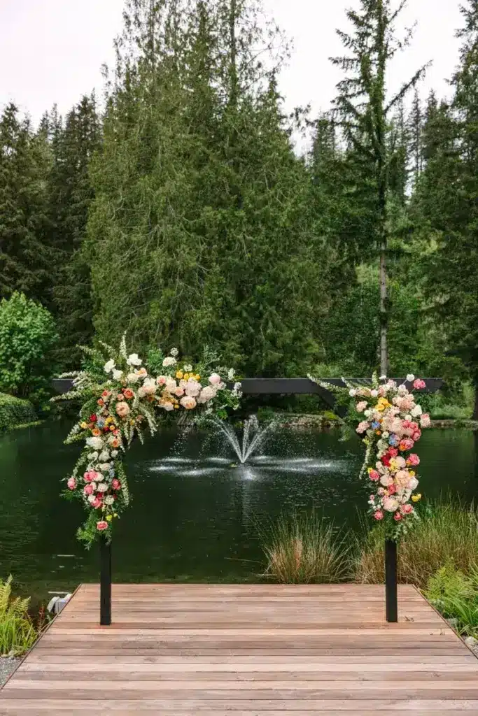 A floral ceremony arch on the dock above the pond at Gray Bridge in Sultan