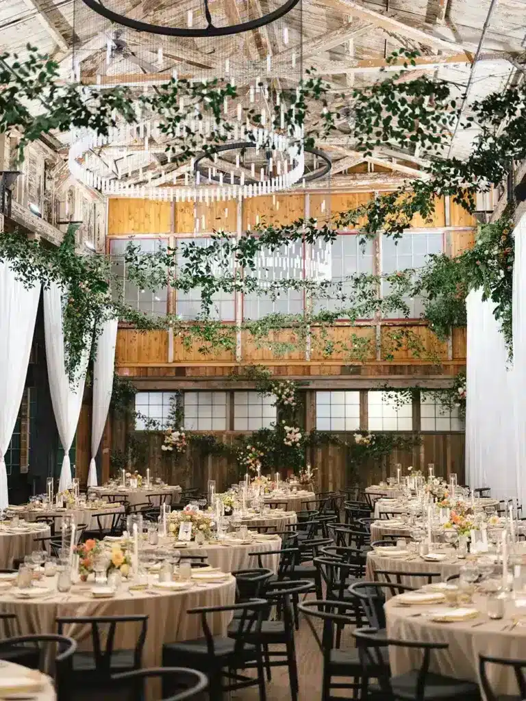 SoDo Park hall dressed in greenery beneath large chandeliers, Seattle