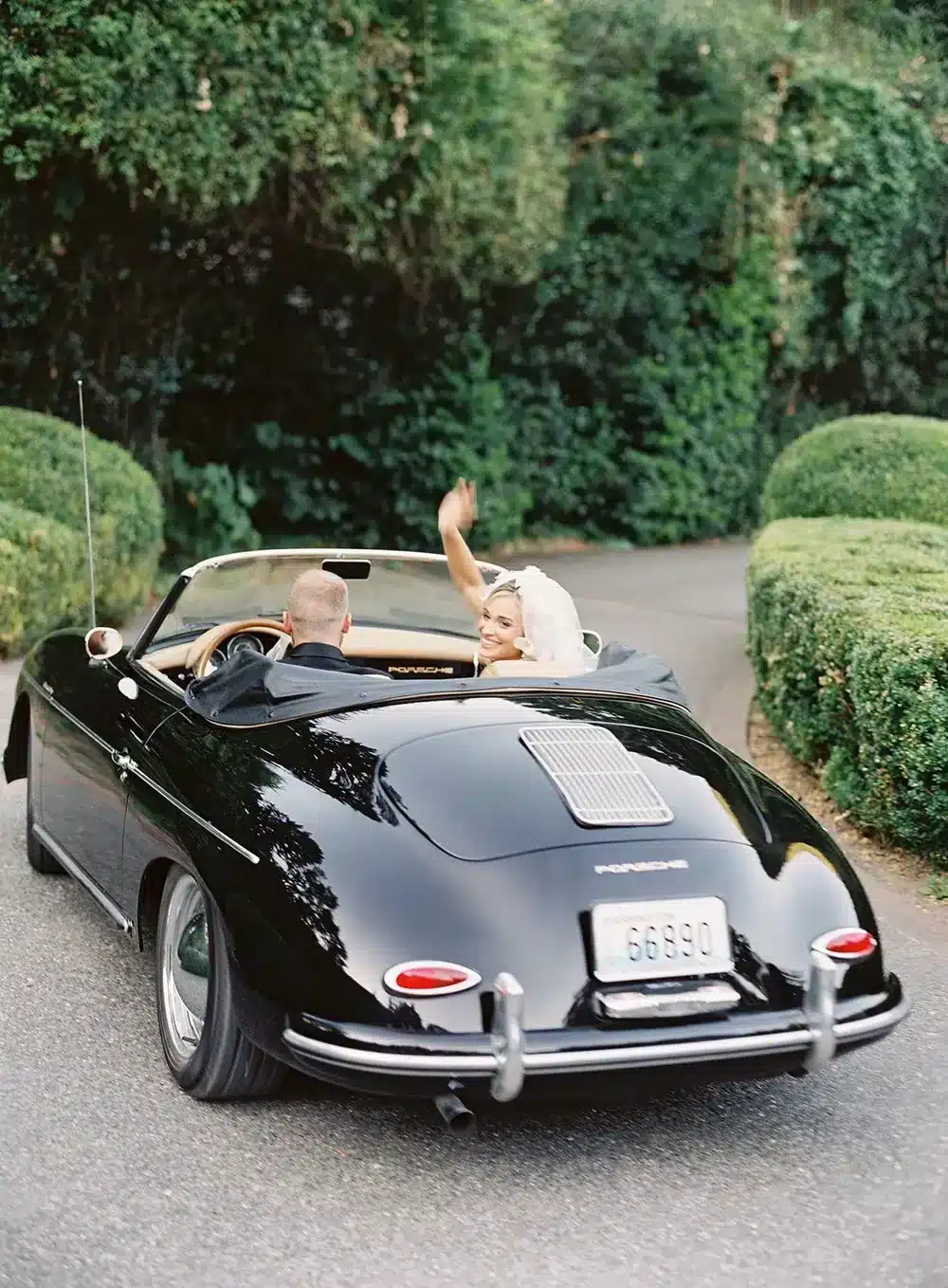 Newlyweds leaving Fox Hollow Farm in a vintage convertible after a small wedding near Seattle